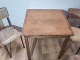 two chairs and a table that are sitting on a hard wood floor