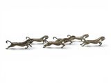 a group of bronze figurines of running dogs on a white background