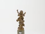 statue of an angel on a pedestal with a plaque in front of a white background
