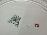 a white plate with a bird on it on a table