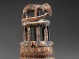 an image of a wooden sculpture with a cat on top of it