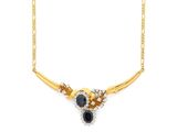 une photo d'un collier en or orné de pierres noires et blanches