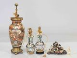 three vases and two other items sitting on a table