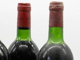 three bottles of wine sitting next to each other on a table