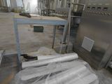 many rolls of plastic sitting on the floor in a factory