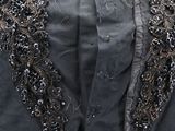 an image of a woman ' s black jacket with silver sequins on it