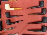 a lot of pipe holders and a bag on the table