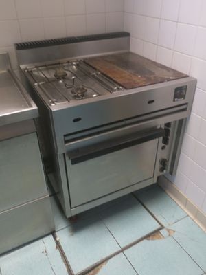 a stove and oven in a small kitchen with tile flooring