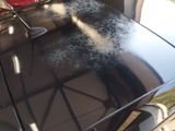 a black car that is being cleaned with a brush