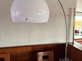a table with wine glasses on it and a lamp above it