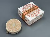 a small box with a decorative design next to it