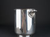 an antique silver ice bucket with a handle on a black background