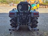 a tractor that is parked in the dirt