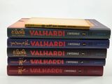 five books stacked on top of each other on a table