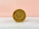 an image of a gold coin on a pink background
