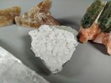 a knife that is next to some rocks and a piece of rock