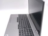 a silver laptop with a black keyboard on a white surface