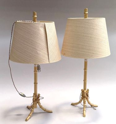 pair of brass table lamps with linen shades on each of them