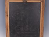 a blackboard with a wooden frame on the wall