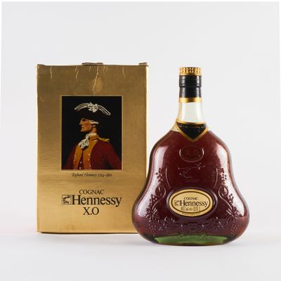 the bottle of hennessy xo is next to the box