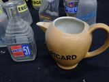 many bottles of water and a pitcher on the table