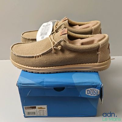 men ' s sued moccali shoes on top of a blue box