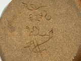 a close up of a brown vase with writing on it