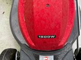 a lawn mower with a red helmet on top of it