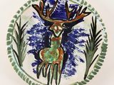 a picture of a decorative plate with a deer on it