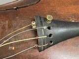 a close up of a violin that is on a table