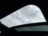 a view of the sky from inside of a car