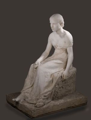 statue en marbre représentant une femme assise sur un rocher