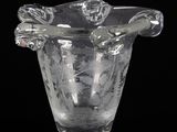 a clear glass vase with a floral design on it