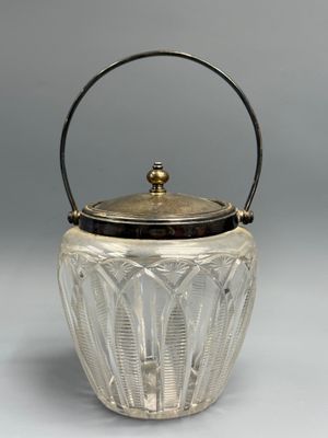 a silver and glass ice bucket with a handle and handle