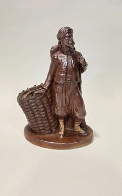 a statue of a woman with a basket on a white surface