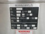 a warning sign on the side of a refrigerator