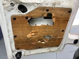 a hole in the door of a car that has been damaged