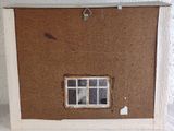 a picture of a doll house with a window in it