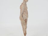 statue of a man standing on a wooden base with a white background