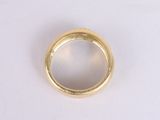 an image of a gold ring sitting on top of a white surface