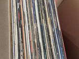 a cardboard box with a bunch of records inside of it