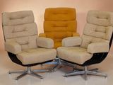 three chairs are sitting side by side on a white floor