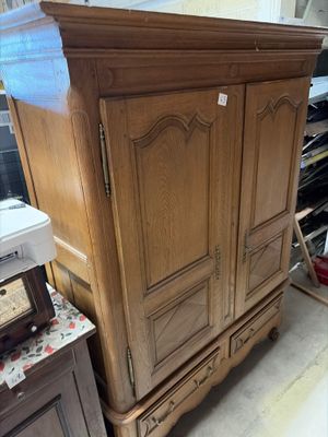 an image of a wooden armoire in a room