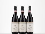 three bottles of wine sitting on top of a table next to each other