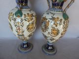 two vases that are sitting on a table