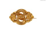 an image of a gold brooch with a snake on it