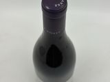 the bottle of wine is sitting on the table ready to be filled