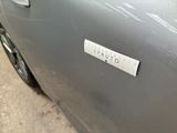 a sticker on the door of a silver car