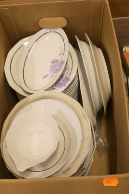 a box full of plates and bowls sitting on the floor
