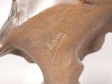 a close up of a statue of a horse with a name written on it